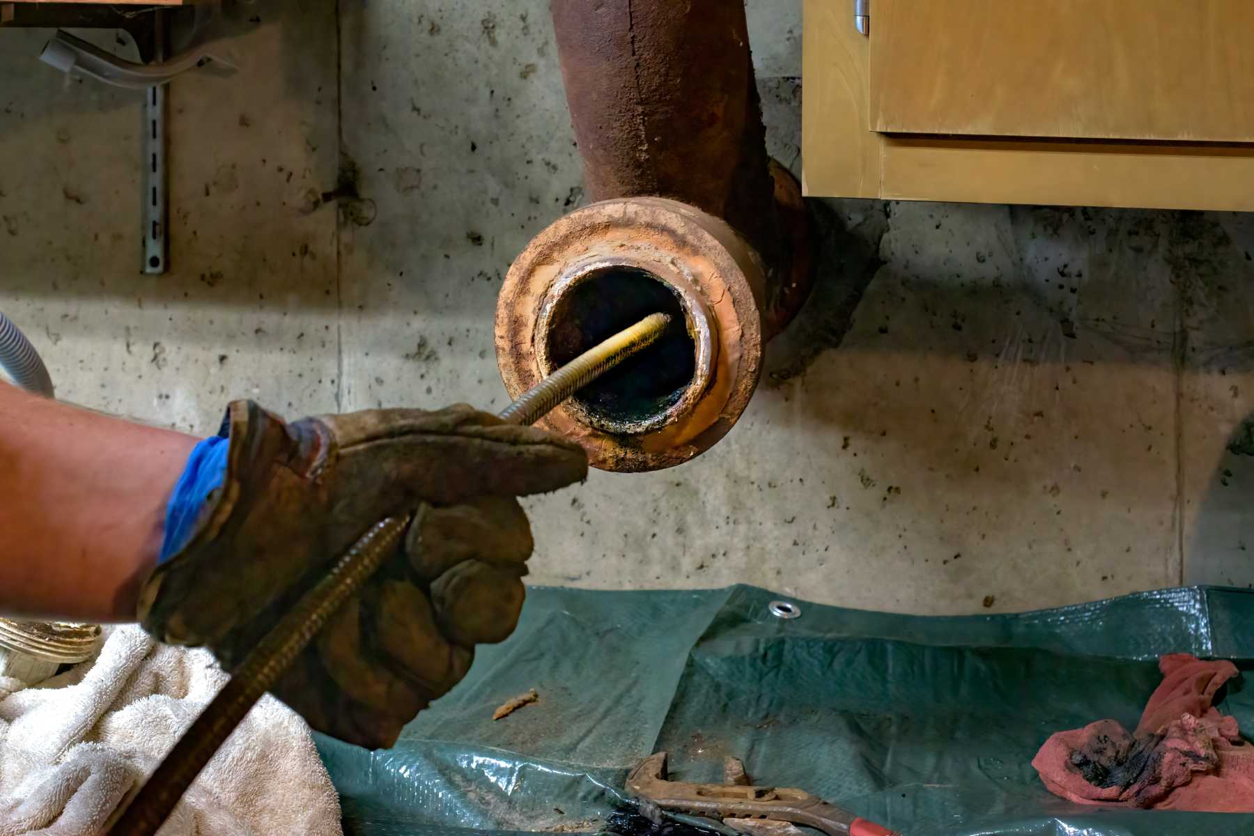 Plumber working on a damaged pipe