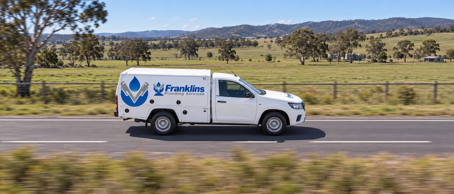 Franklins Plumbing Services ute driving along a country road