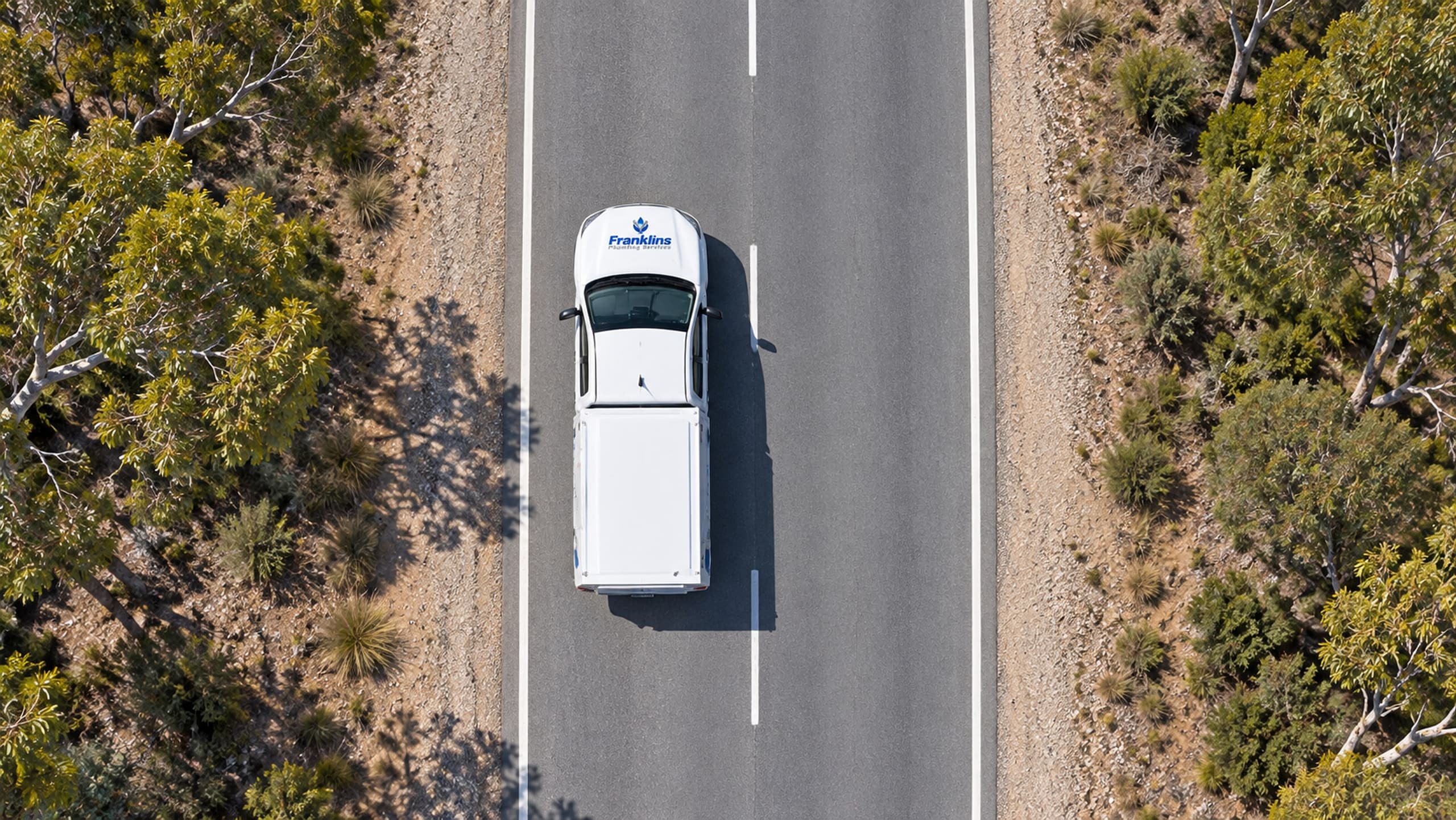 Overhead view of a Franklins Plumbing Services ute on the road