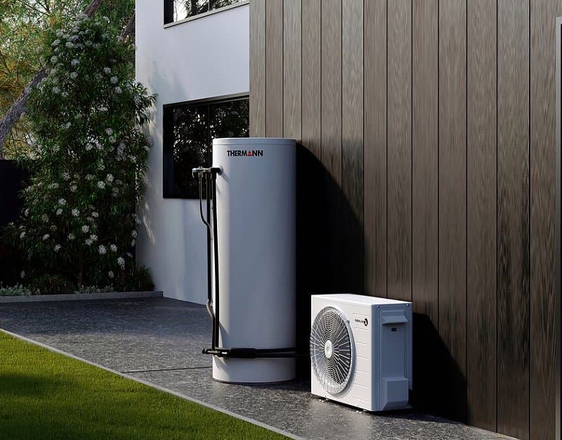 Heat pump hot water system installed beside a house